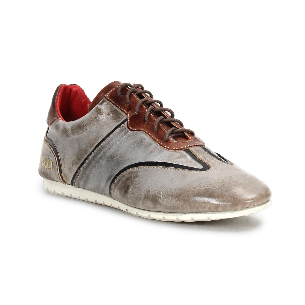 The Scurry sneaker by Bed|Stü is a gray and brown retro-inspired shoe made from vegetable-tanned leather, featuring black stitching, a lace-up front, red inner lining, and a white rubber sole for everyday durability. The shoe is positioned at an angle on a white background.