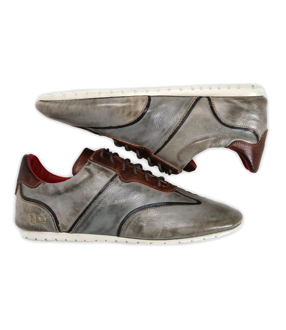 The Bed|Stü Scurry sneakers, crafted from gray vegetable-tanned leather with brown accents, white soles, and a red inner lining, are displayed against a white background—delivering everyday durability in a retro-inspired design.