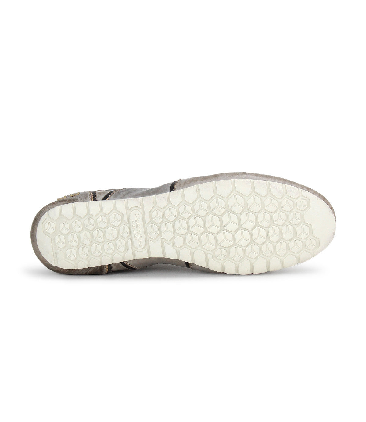 The image shows the bottom view of the Bed|Stü Scurry sneaker, featuring a white, hexagon-patterned rubber sole against a plain background, emphasizing its retro-inspired style and everyday durability.