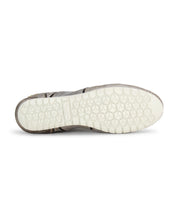 The image shows the bottom view of the Bed|Stü Scurry sneaker, featuring a white, hexagon-patterned rubber sole against a plain background, emphasizing its retro-inspired style and everyday durability.