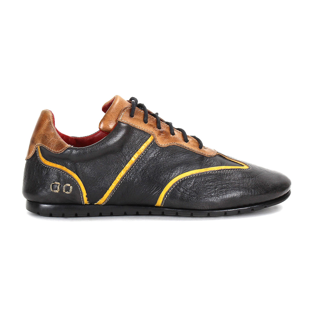 The Bed|Stü Scurry is a black and brown retro-inspired sneaker made from vegetable-tanned leather with yellow accents, featuring a low-profile design, durable rubber sole, and lace-up closure—shown in a left side profile view on a white background.