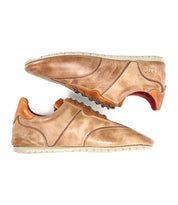 A pair of Bed|Stü Scurry tan vegetable-tanned leather sneakers with light soles, brown accents, and a red inner lining are displayed side by side on a white background, highlighting their everyday durability and retro-inspired style.