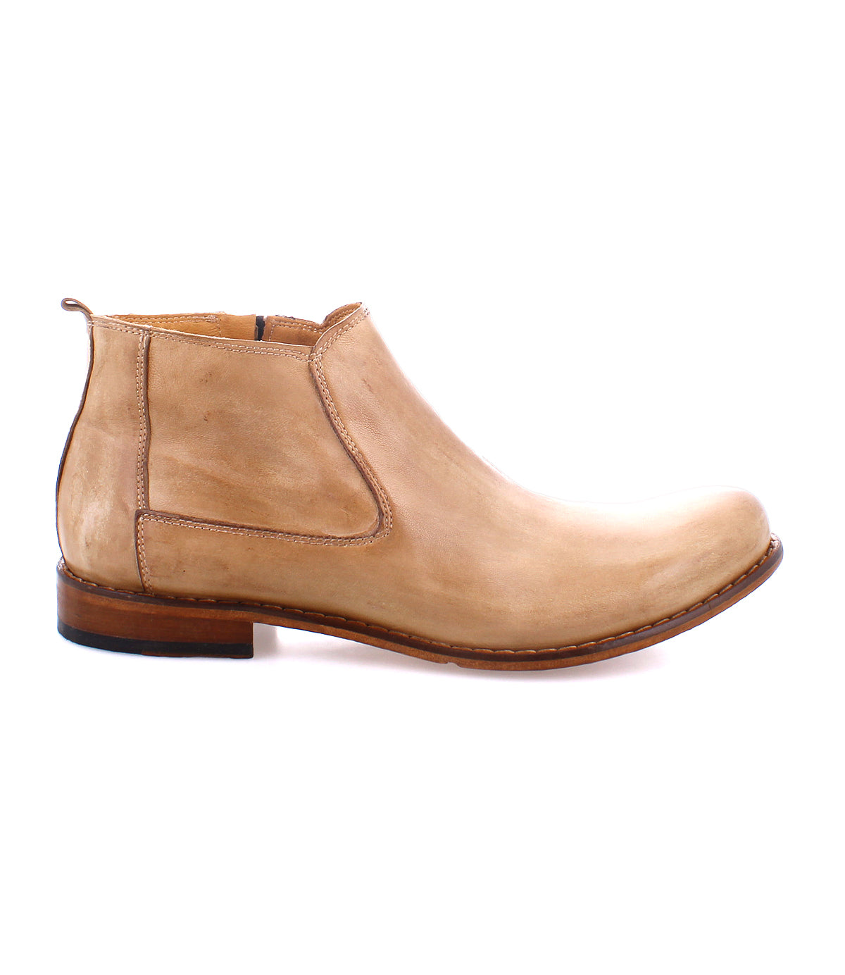 The Bed|Stü Seek is a light brown Chelsea boot, handmade in Italy from premium vegetable-tanned leather, featuring a low heel and slip-on design, displayed in a side profile against a white background.