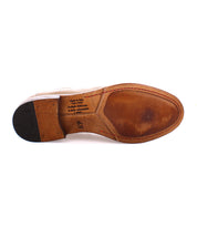Bottom view of the Bed|Stü Seek Chelsea boot in brown vegetable-tanned leather, showing visible wear, a partially rubber heel, and text indicating it is handmade in Italy, size 45.