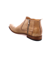 The Seek Chelsea boot by Bed|Stü is handmade in Italy from vegetable-tanned tan leather, featuring a side zipper and wooden sole, shown from the back left angle against a white background.