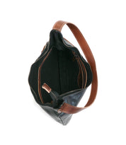 Top view of the Seemly by Bed|Stü—an open black leather handbag with brown handles and trim, featuring a stylish buckle detail, zippered compartment, and black interior lining—perfect for everyday styling.