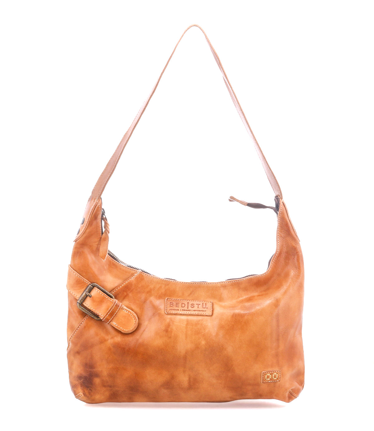 The Seemly by Bed|Stü is a light brown leather shoulder bag featuring a single strap, decorative buckle detail, visible stitching, and a zippered top. This compact bag is finished with logo and small patch accents on the front—perfect for everyday styling.