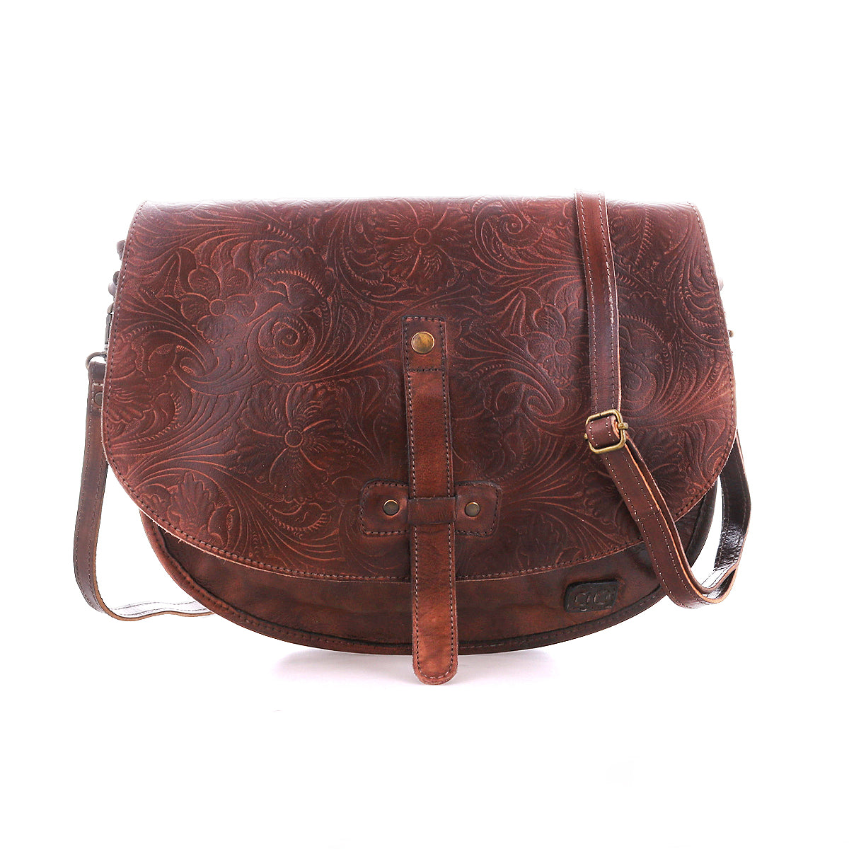 The Bed|Stü Sequoia EM is a brown vegetable-tanned leather crossbody bag featuring a floral embossed pattern, adjustable strap, and front buckle detail, shown against a white background.