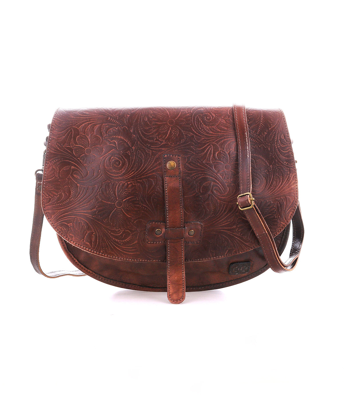 The Bed|Stü Sequoia EM is a brown vegetable-tanned leather crossbody bag featuring a floral embossed pattern, adjustable strap, and front buckle detail, shown against a white background.