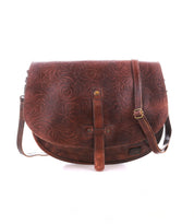 The Bed|Stü Sequoia EM is a brown vegetable-tanned leather crossbody bag featuring a floral embossed pattern, adjustable strap, and front buckle detail, shown against a white background.
