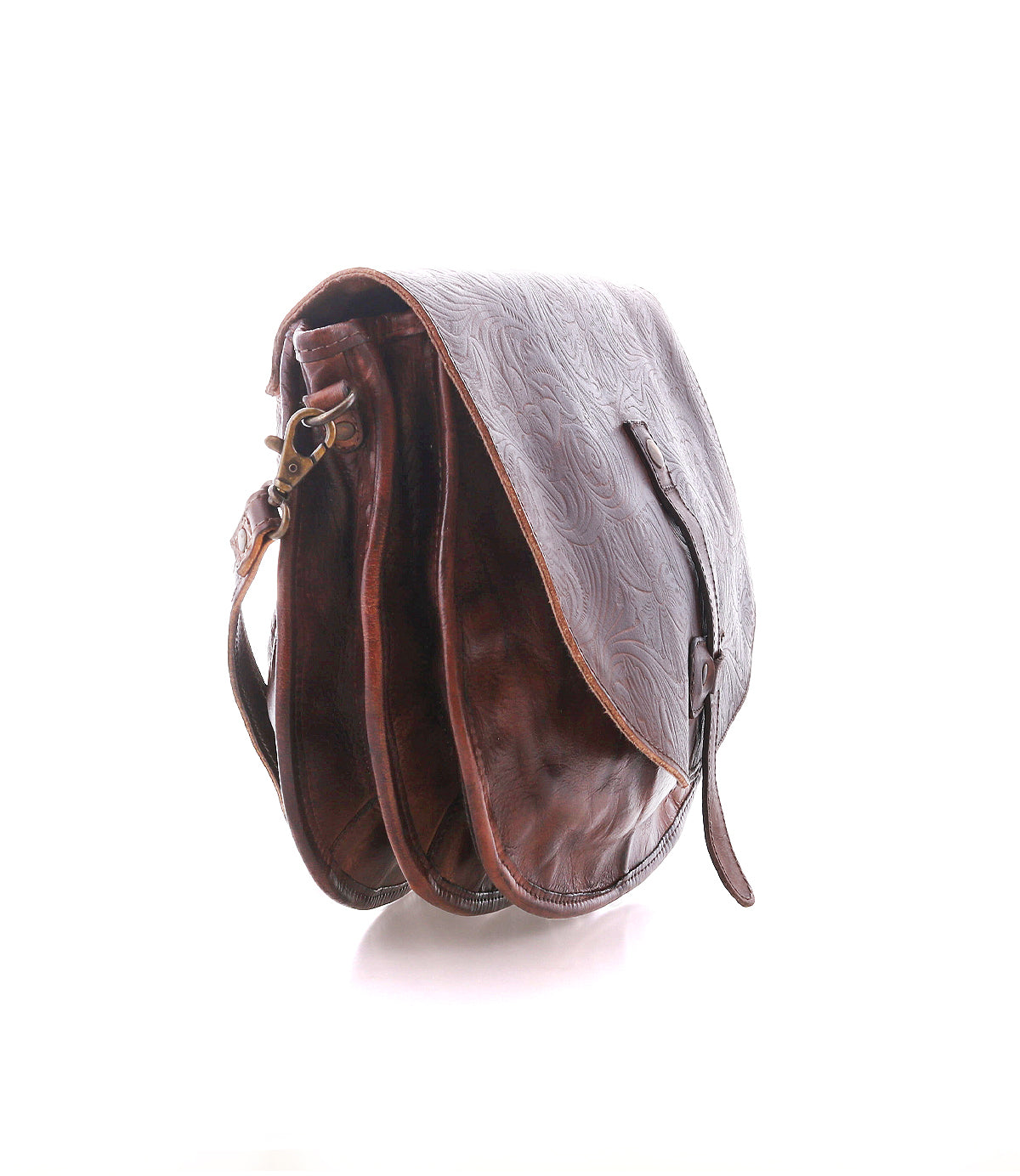 The Sequoia EM crossbody bag by Bed|Stü is crafted from vegetable-tanned brown leather with an embossed pattern, featuring a flap cover and adjustable strap. Shown on a white background, this saddle bag blends timeless style with durable functionality.