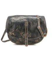 The Bed|Stü Sequoia messenger bag, crafted from distressed black vegetable-tanned leather, features a flap closure and an adjustable crossbody strap, displayed against a white background.