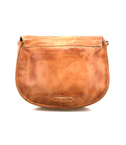 Sequoia is a light brown shoulder bag by Bed|Stü, expertly crafted from premium vegetable-tanned leather. It features a flap closure with rounded edges, and the brand name "Bed|Stü" is embossed on a small metal plate at the bottom front center of the bag for an elegant finishing touch.