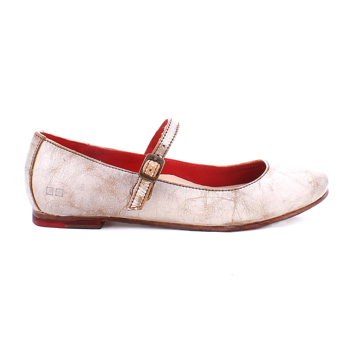 A side-profile image of the Bed|Stü Shuffle III, a worn beige Mary Jane ballet flat crafted from supple leather, features a buckle strap, red interior lining, and slight scuff marks, set against a white background.