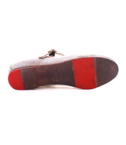 The image displays the underside of the Bed|Stü Shuffle III men's dress shoe, featuring red and brown sections on the leather sole with imprinted branding in the center, crafted from supple leather for a refined look reminiscent of classic feminine footwear.