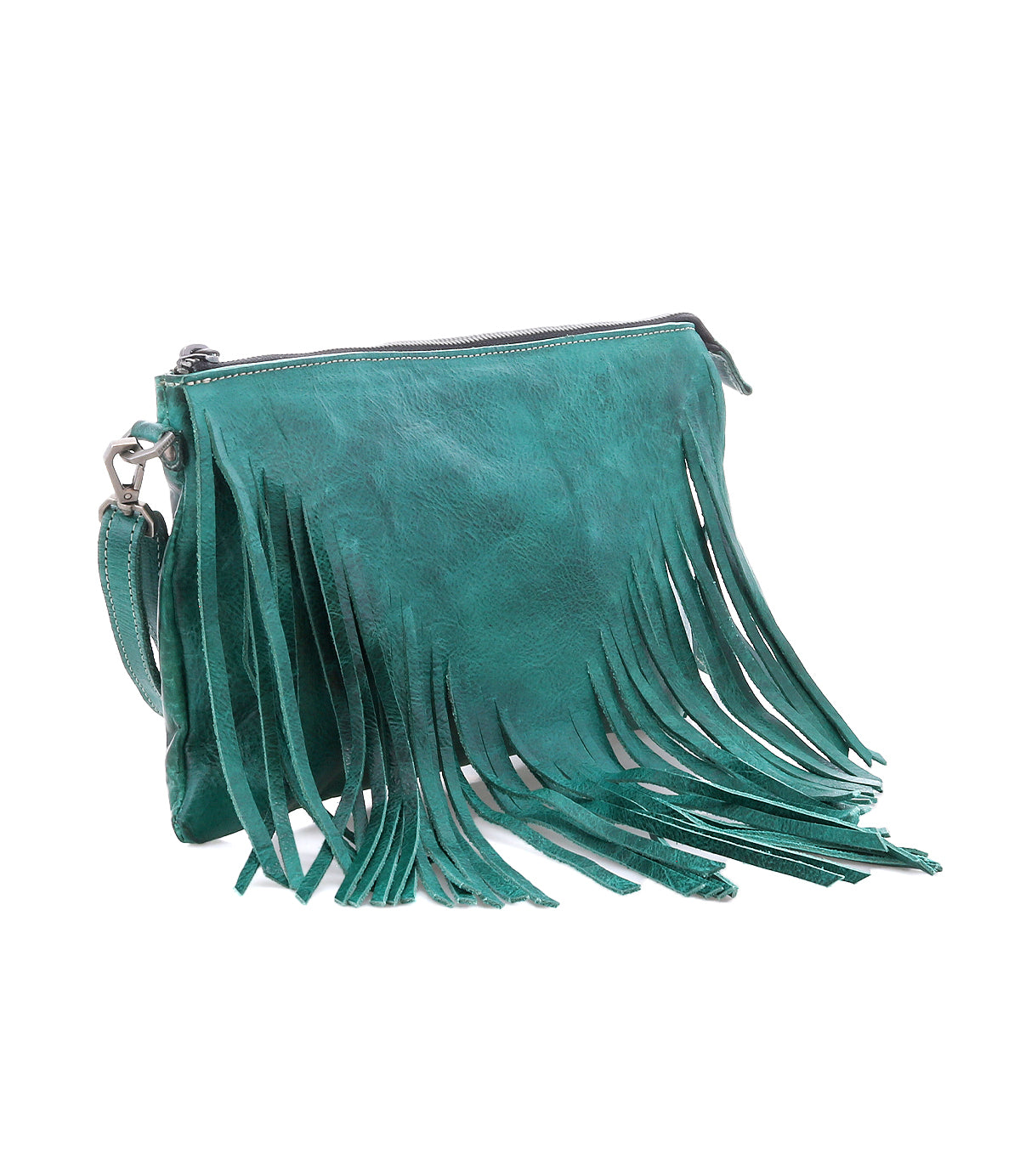 A teal leather clutch bag by Bed|Stü, the Silverrock features a zipper closure and long fringe detailing on the front and sides, effortlessly transitioning from a statement clutch to a small crossbody bag for versatile styling.