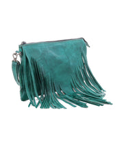 A teal leather clutch bag by Bed|Stü, the Silverrock features a zipper closure and long fringe detailing on the front and sides, effortlessly transitioning from a statement clutch to a small crossbody bag for versatile styling.