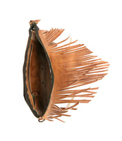 Bed|Stü’s Silverrock brown leather fringe clutch purse is shown open from a side angle, revealing its zippered compartment and internal sections; this stylish accessory also offers the versatility to be worn as a small crossbody bag.