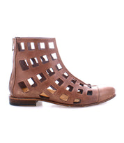 The Skyline by Bed|Stü is a brown leather ankle boot, handcrafted in Italy, with large square cutouts across the upper and a back zipper, shown in side profile on a white background.
