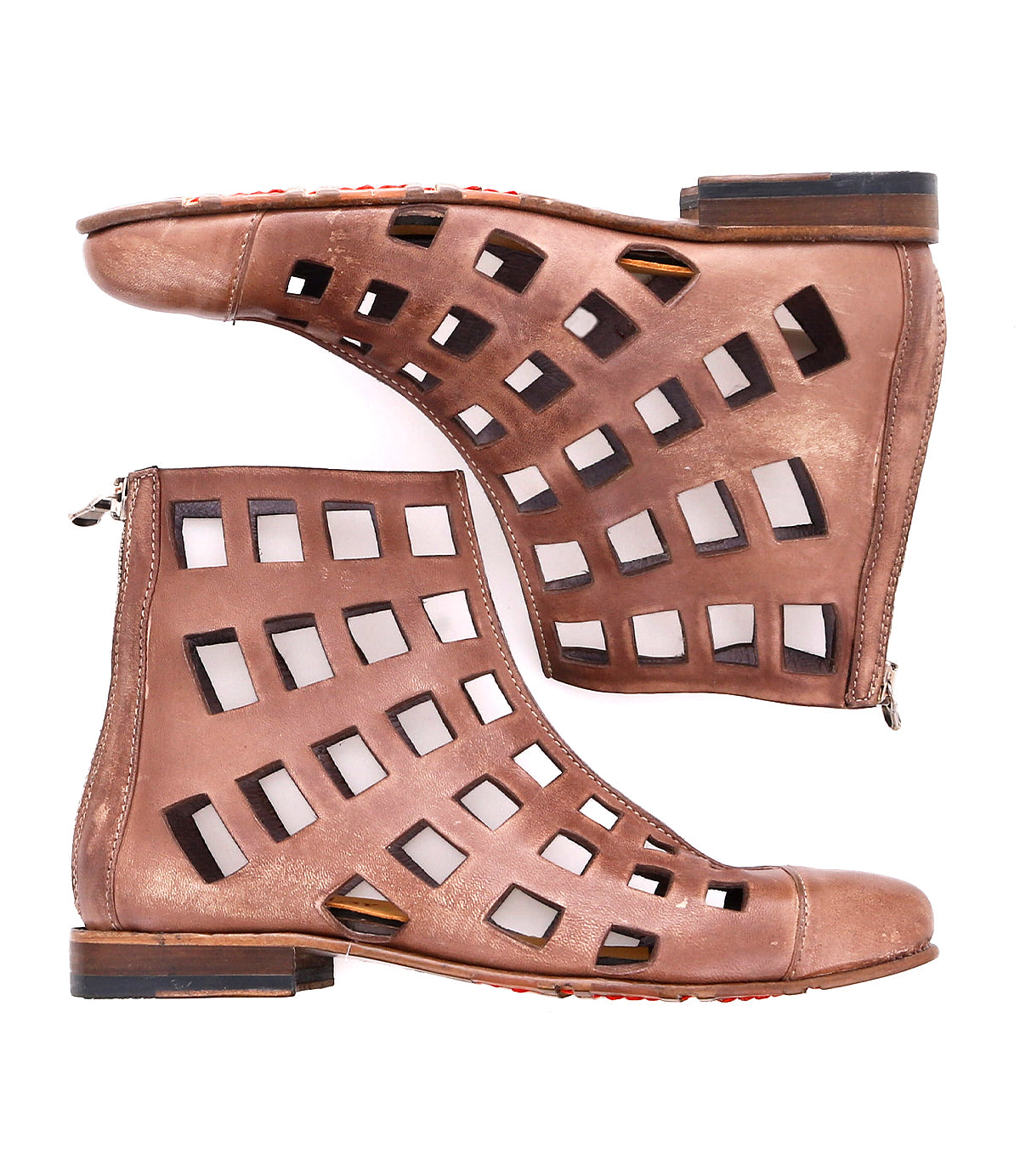 The Bed|Stü Skyline boots are a pair of brown ankle boots featuring square cut-out patterns, handcrafted in Italy, shown side by side on a white background with visible side zippers and flat wooden heels.