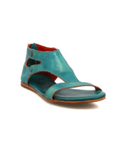 The Soto sandal by Bed|Stü features a turquoise cutout leather design with an open toe, ankle-high profile, cushioned footbed for comfort, and cutout sides—ideal for everyday adventures—shown against a white background.