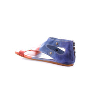 The Soto sandal by Bed|Stü features a flat leather cutout design with a striking red and blue gradient, side cutouts, metal snaps, and a back zipper—all set on a white background. Its cushioned footbed makes it perfect for everyday exploring.