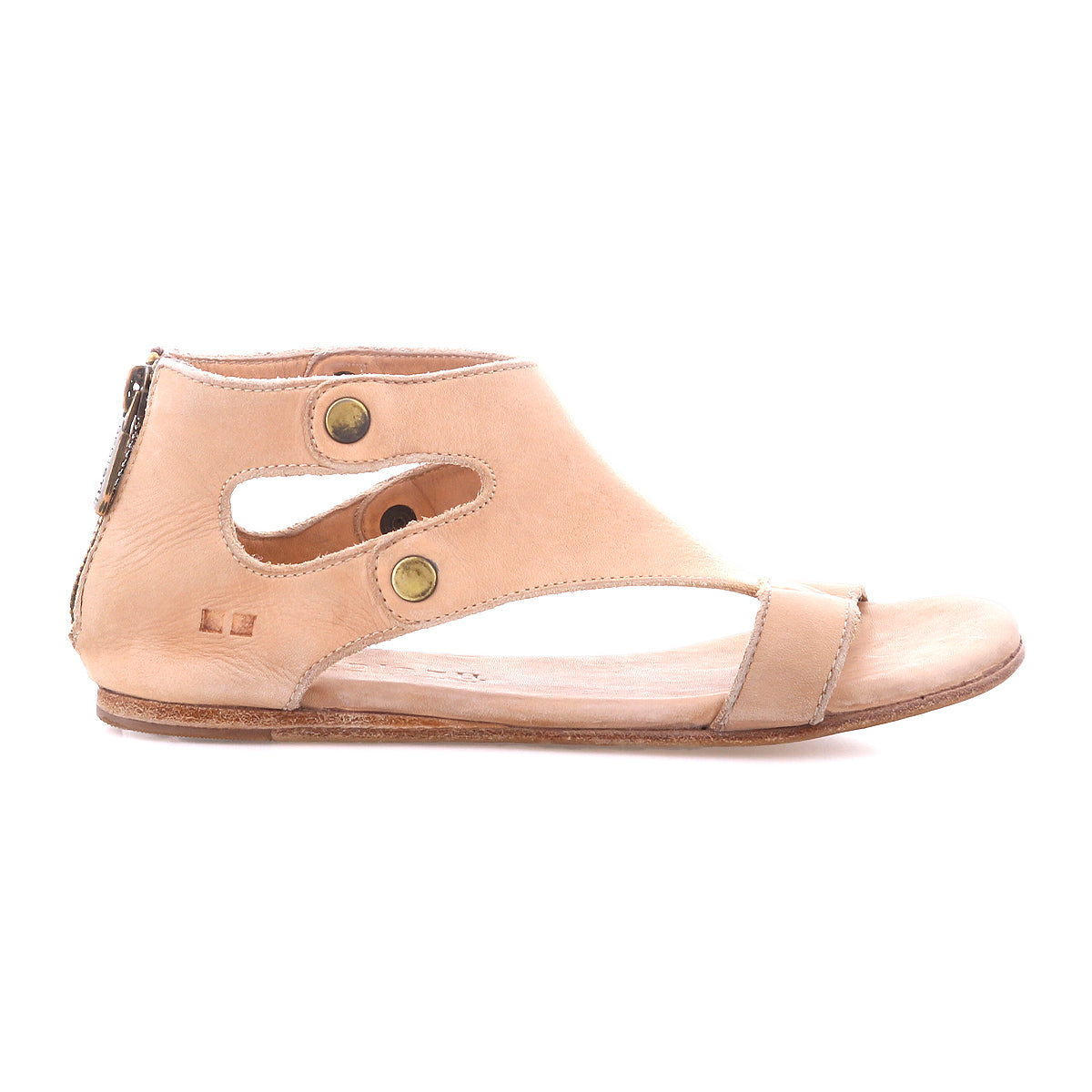 The Soto sandal by Bed|Stü features a beige cutout leather design with an ankle-high silhouette, cushioned footbed for all-day comfort, two brass buttons, a side zipper for easy wear, and a flat sole—shown here in profile view.