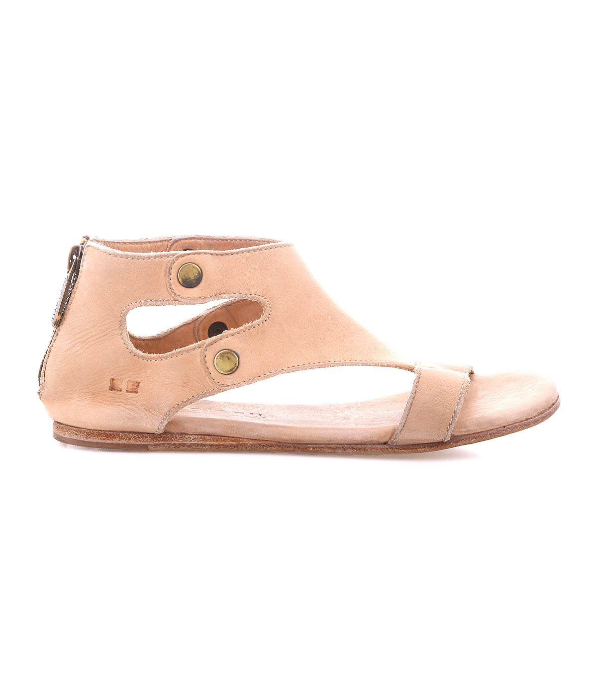 The Soto sandal by Bed|Stü features a beige cutout leather design with an ankle-high silhouette, cushioned footbed for all-day comfort, two brass buttons, a side zipper for easy wear, and a flat sole—shown here in profile view.