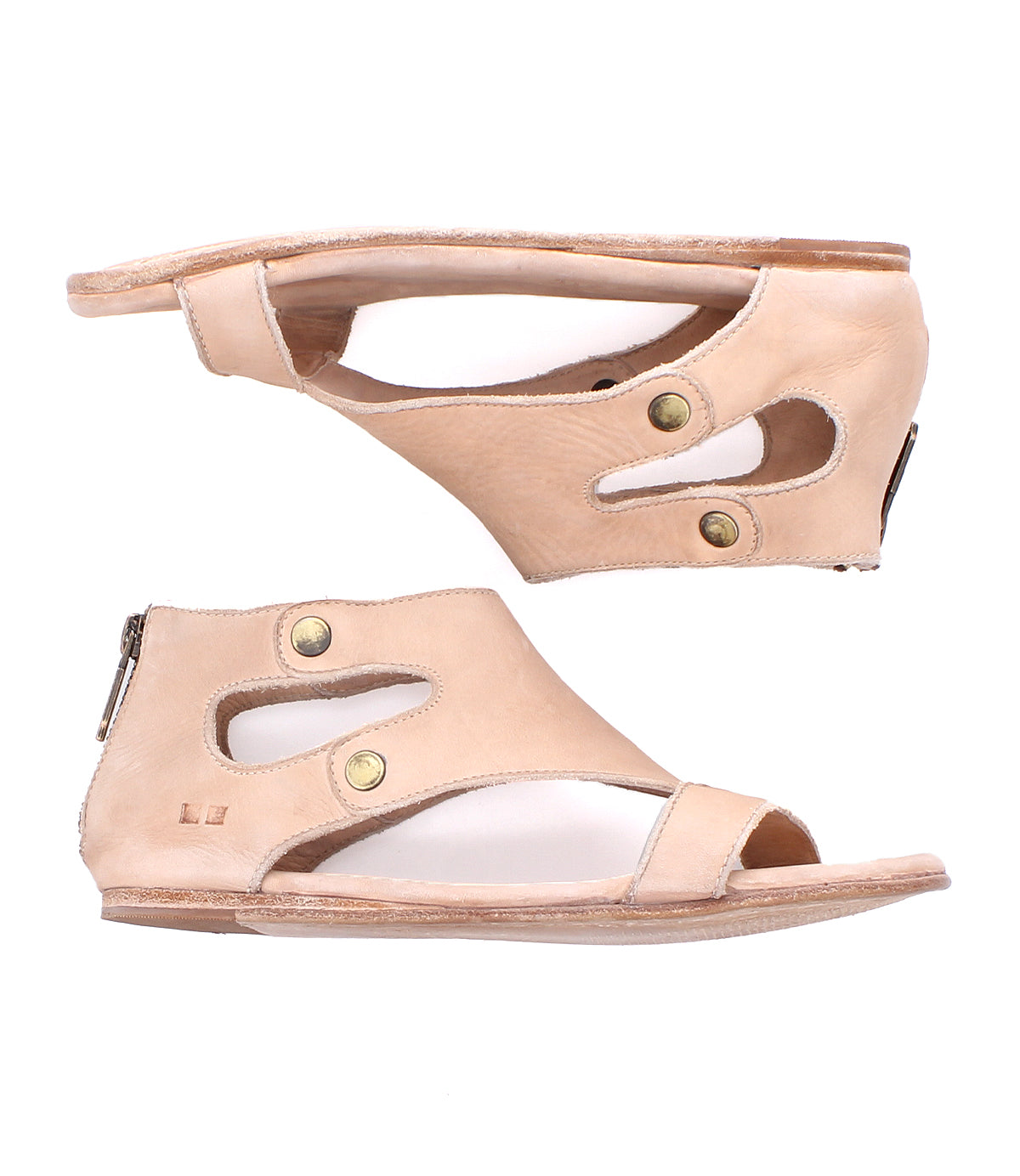 Two tan cutout leather "Soto" sandals by Bed|Stü, featuring open toes, brass snap details, and heel zipper closures, are shown from the side against a white background. Designed for everyday exploring, these sandals include a cushioned footbed to provide enhanced comfort with every step.
