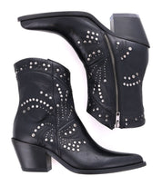 A pair of Sposa black Italian ankle boots by Bed|Stü, crafted from vegetable-tanned leather with silver studs, side zippers, and chunky heels. One boot is shown upright while the other is positioned on its side.