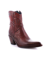 Showcased against a white background, the Sposa by Bed|Stü is an Italian ankle boot crafted from vegetable-tanned brown leather, featuring a pointed toe, patterned stitching, metal stud accents, and a chunky heel for enduring quality and style.
