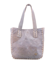 Introducing Stevie by Bed|Stü—a gray leather tote bag featuring double handles and decorative stitching along its edges. A small metal Bed|Stü logo plate accents the lower right corner. This classic tote seamlessly blends timeless style with everyday practicality, making it the perfect carryall for daily use.