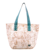 Introducing Stevie by Bed|Stü—a large beige and brown leather tote featuring visible stitching, a marbled texture, and striking blue-green handles. Displayed on a white background, this stylish vintage-inspired bag is perfect for everyday carry.