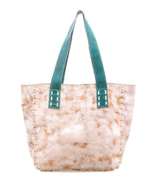 The Bed|Stü Stevie is a tan and white tie-dye tote bag featuring teal handles and decorative stitching along the sides, making it perfect as an everyday carry. Shown here against a white background.
