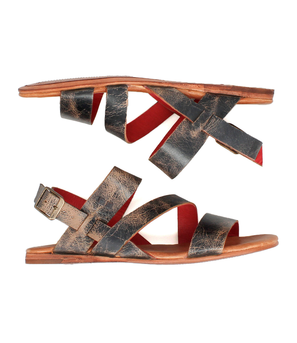 Superb by Bed|Stü: Flat leather sandals featuring distressed black leather straps, an adjustable ankle strap with a buckle on one side, red interior lining, and brown soles—shown in a side view and designed for everyday comfort.