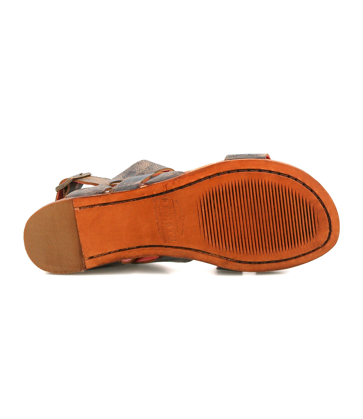 The Bed|Stü Superb brown leather sandal is displayed sole up, showcasing its textured orange-brown rubber sole with stitched edges and a rectangular textured detail near the heel—perfect for everyday wear.