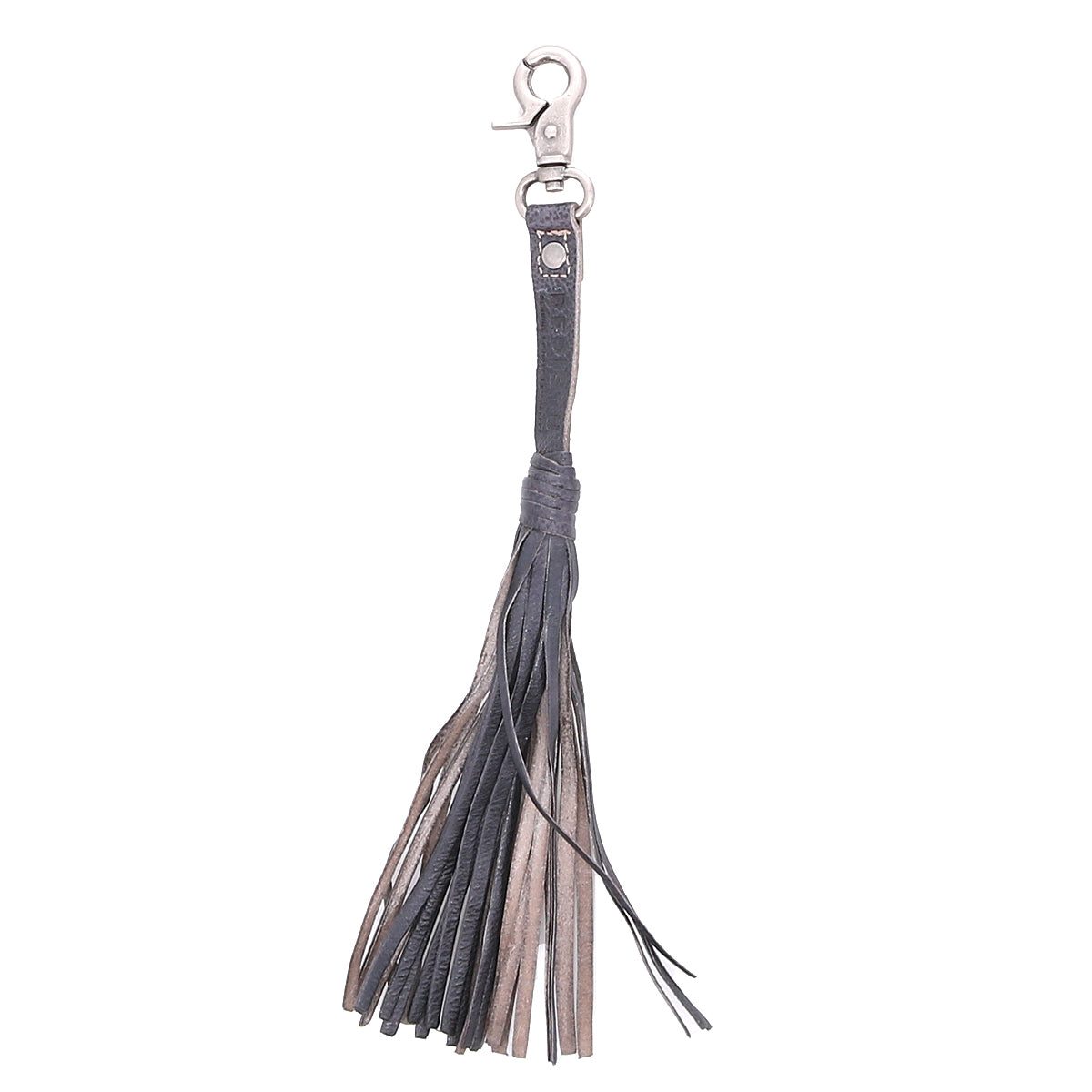 The Bed|Stü Tassel Clip, crafted from black and brown leather with a silver clasp, is displayed against a white background—this stylish accessory serves as both a chic keychain charm and a versatile bag adornment.