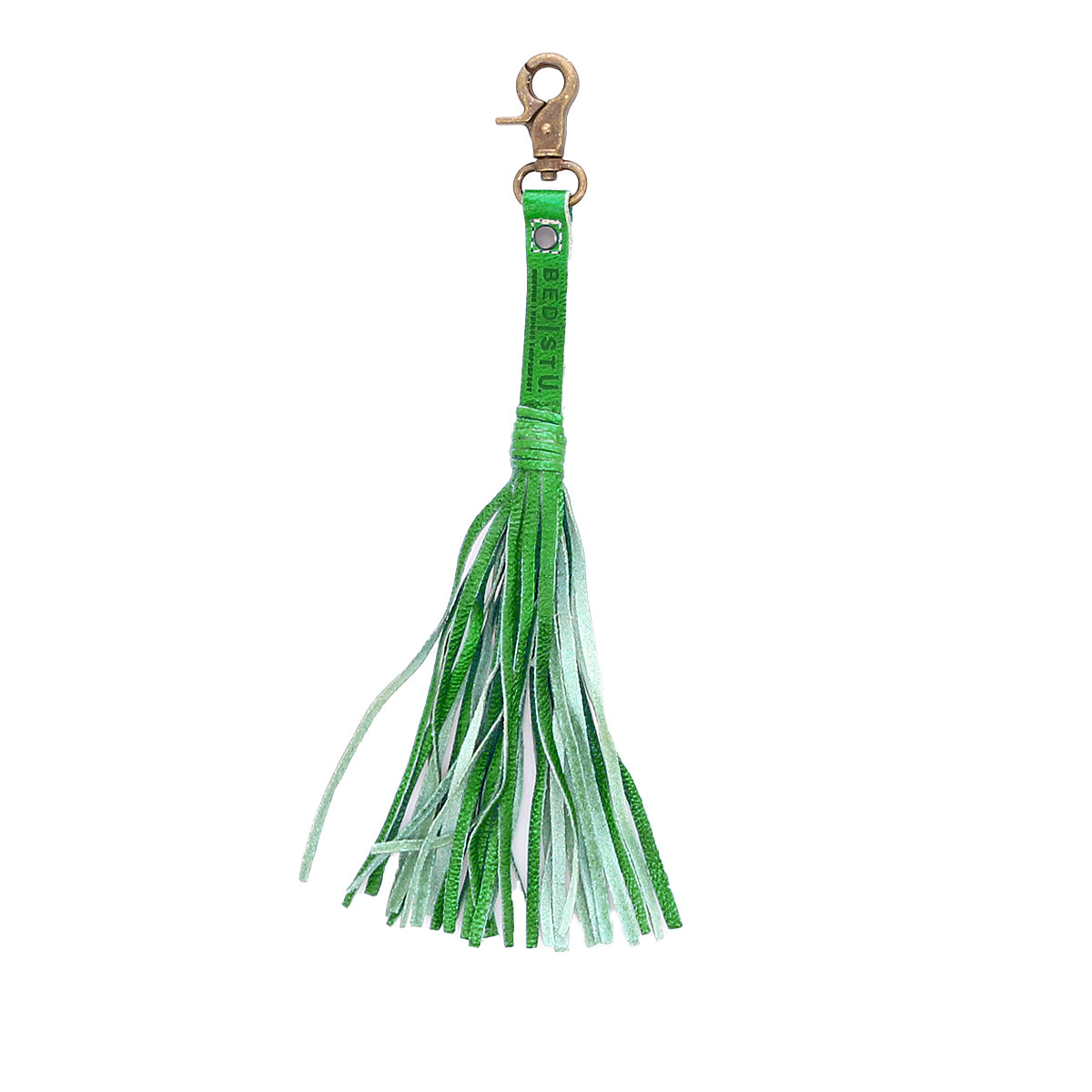 Add a touch of flair to your favorite tote with the Bed|Stü Tassel Clip—a chic green leather tassel keychain featuring multiple thin fringe strands and a gold-tone lobster clasp. This stylish bag accessory doubles as a keychain charm or leather tassel clip.