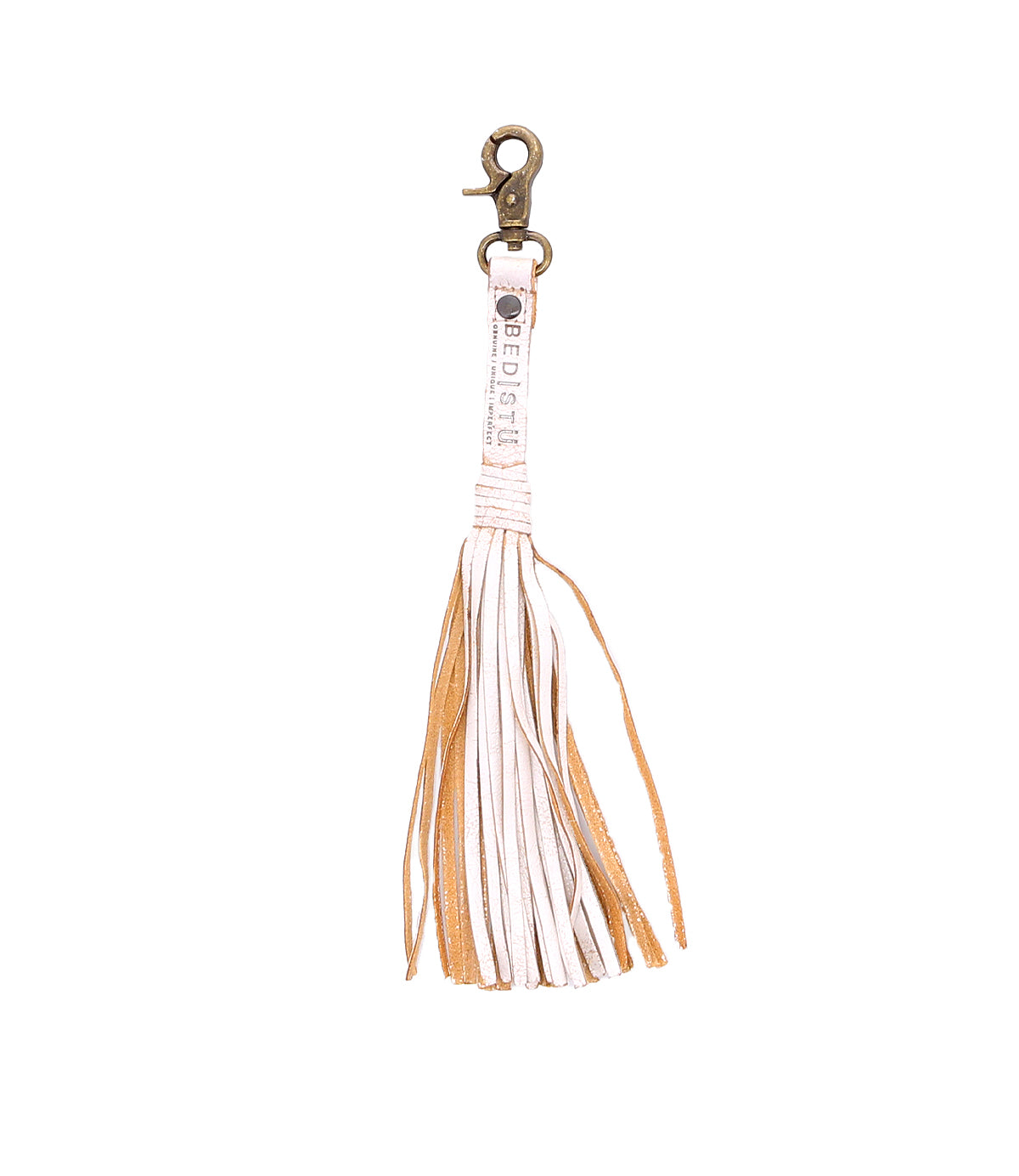 The Bed|Stü Tassel Clip is a tan and white leather keychain with a metal clasp, shown against a white background, making it a stylish bag accessory or charm.