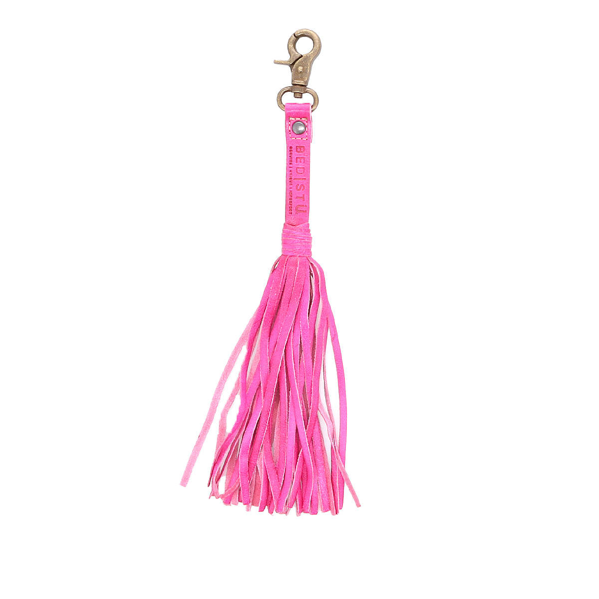 A pink leather tassel clip with a gold clasp and "Bed|Stü" branding on the strap, this stylish Tassel Clip doubles as a chic bag accessory or keychain charm.