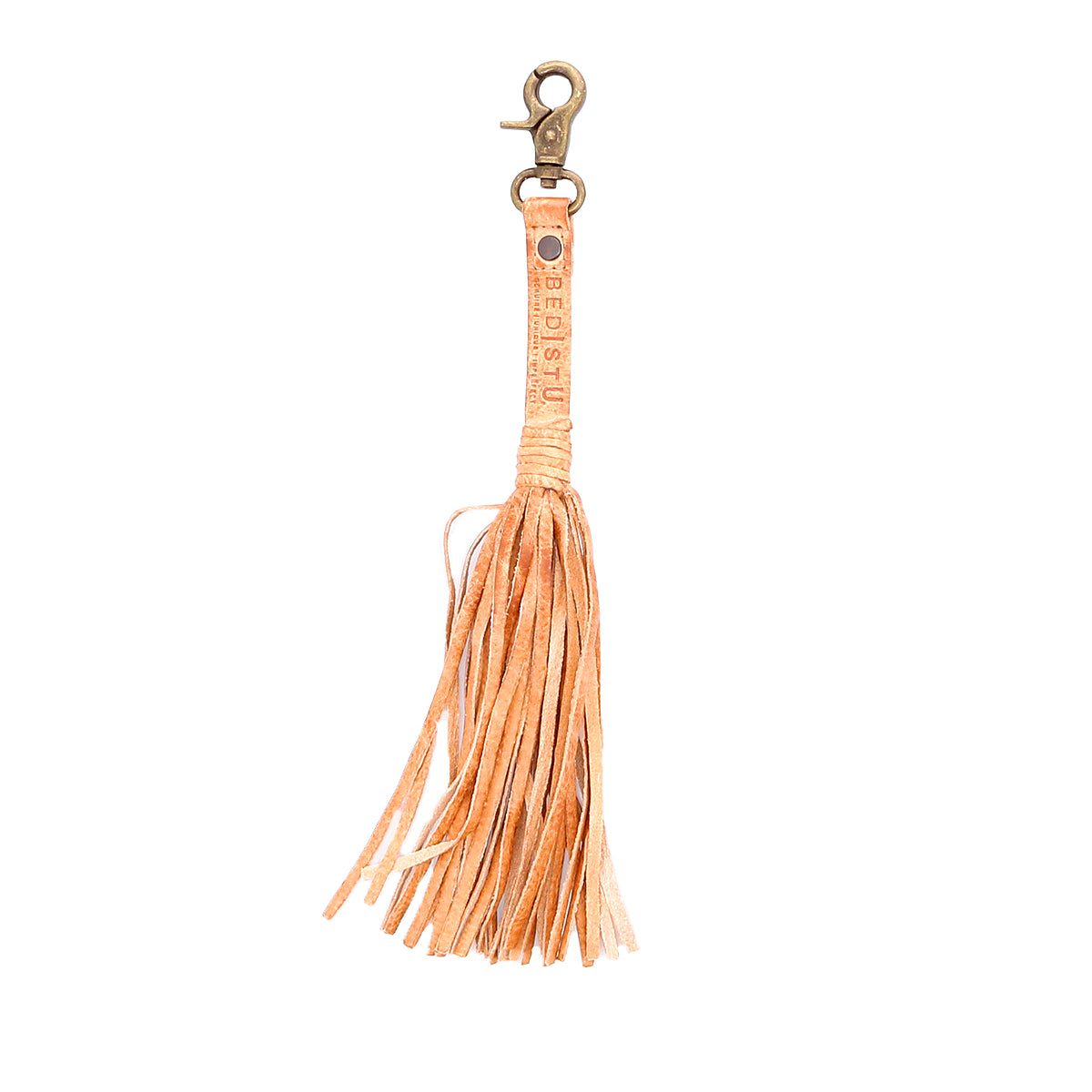 Tan leather Tassel Clip by Bed|Stü, featuring fringed strands, a metal clasp, and "Bed|Stü" embossed on the strap—a chic keychain charm that elevates your everyday look.