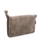 The Templeton II by Bed|Stü is a brown leather zippered pouch featuring a subtle stitched logo in the bottom right corner, ideal for use as a minimalist wallet or clutch, shown here against a white background.
