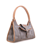 Discover Bed|Stü’s "Unbending": a gray washed leather handbag accented with tan trim. Featuring a structured, rectangular silhouette, this minimalist bag includes a short handle, an exterior pocket, and a front flap with buckle closure—making it the perfect polished work bag or versatile everyday shoulder accessory.