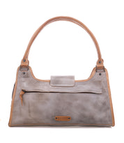 The Unbending by Bed|Stü is a rectangular handbag in light gray washed leather with tan handles and trim, featuring a front zipper pocket and a flap closure—perfect as a stylish work-bag.