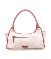 The "Unbending" shoulder bag by Bed|Stü is crafted from beige washed leather with striking red handles and trim. It features a front zipper pocket and a small brand tag, photographed against a white background—an elegant choice for a work bag.