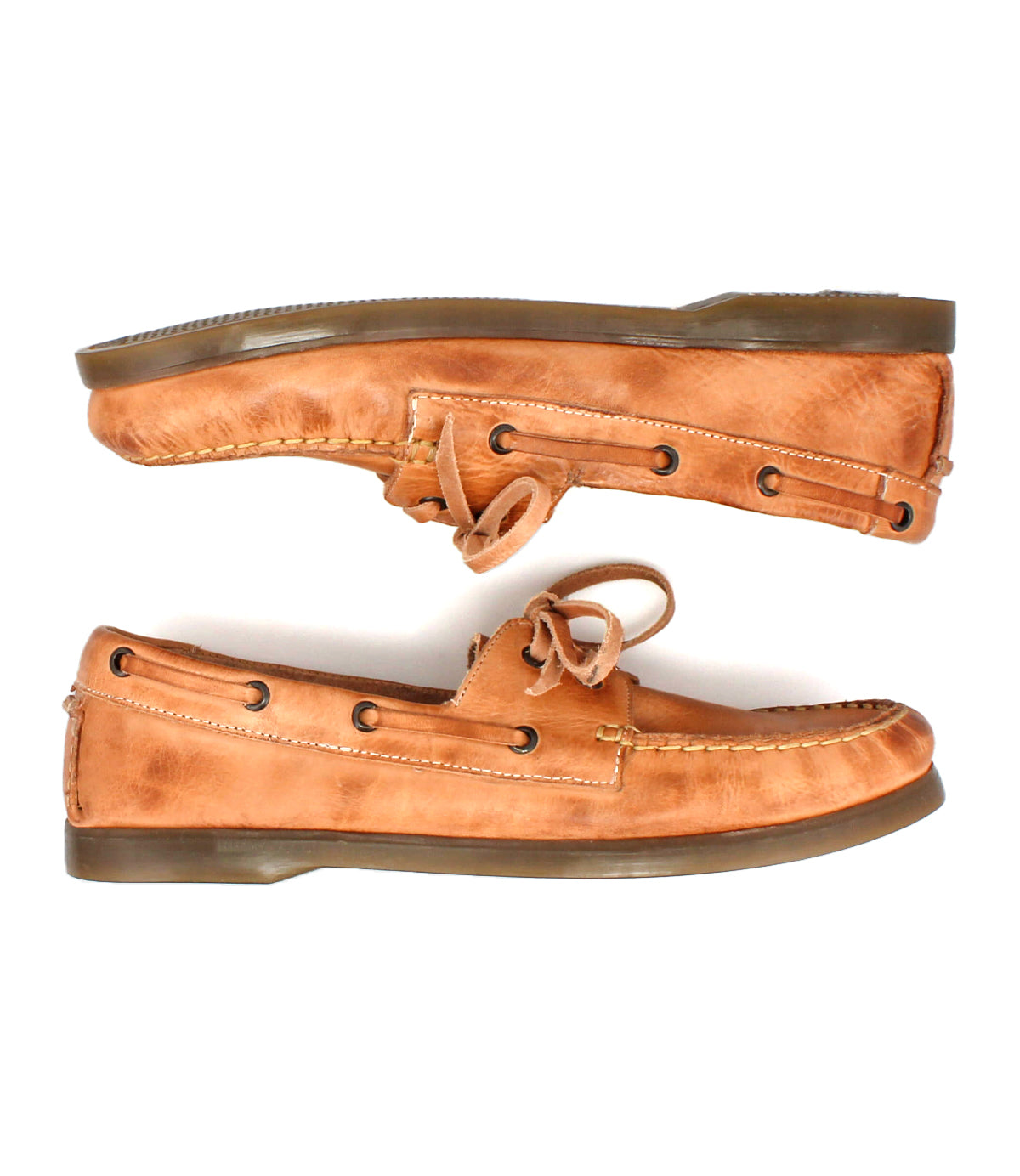 Two Uncle Floyd hand-finished tan leather boat shoes by Bed|Stü, with brown soles and laces and classic moc-toe stitching, are positioned in opposite directions on a white background.