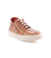 Introducing the Unwavering sneakers by Bed|Stü—expertly handwoven leather shoes in beige and tan hues, showcasing a dimensional pattern with lace-up closure, a crisp white rubber sole, and a low-top silhouette, elegantly presented against a white background.