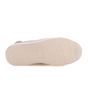 The image features the beige, ribbed sole of the Bed|Stü Unwavering sneaker, displayed horizontally with the toe on the right and the heel on the left, set against a white background.