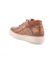 Unwavering by Bed|Stü: Brown and tan handwoven leather sneakers with a white sole, showcasing a bold dimensional pattern, viewed from the back left side against a plain white background.