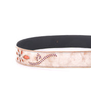 A partial view of the Bed|Stü Upswing II, a light-colored handcrafted leather belt featuring orange and purple floral and swirl stitching.